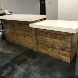 Large solid wood reception desk sitting in an office